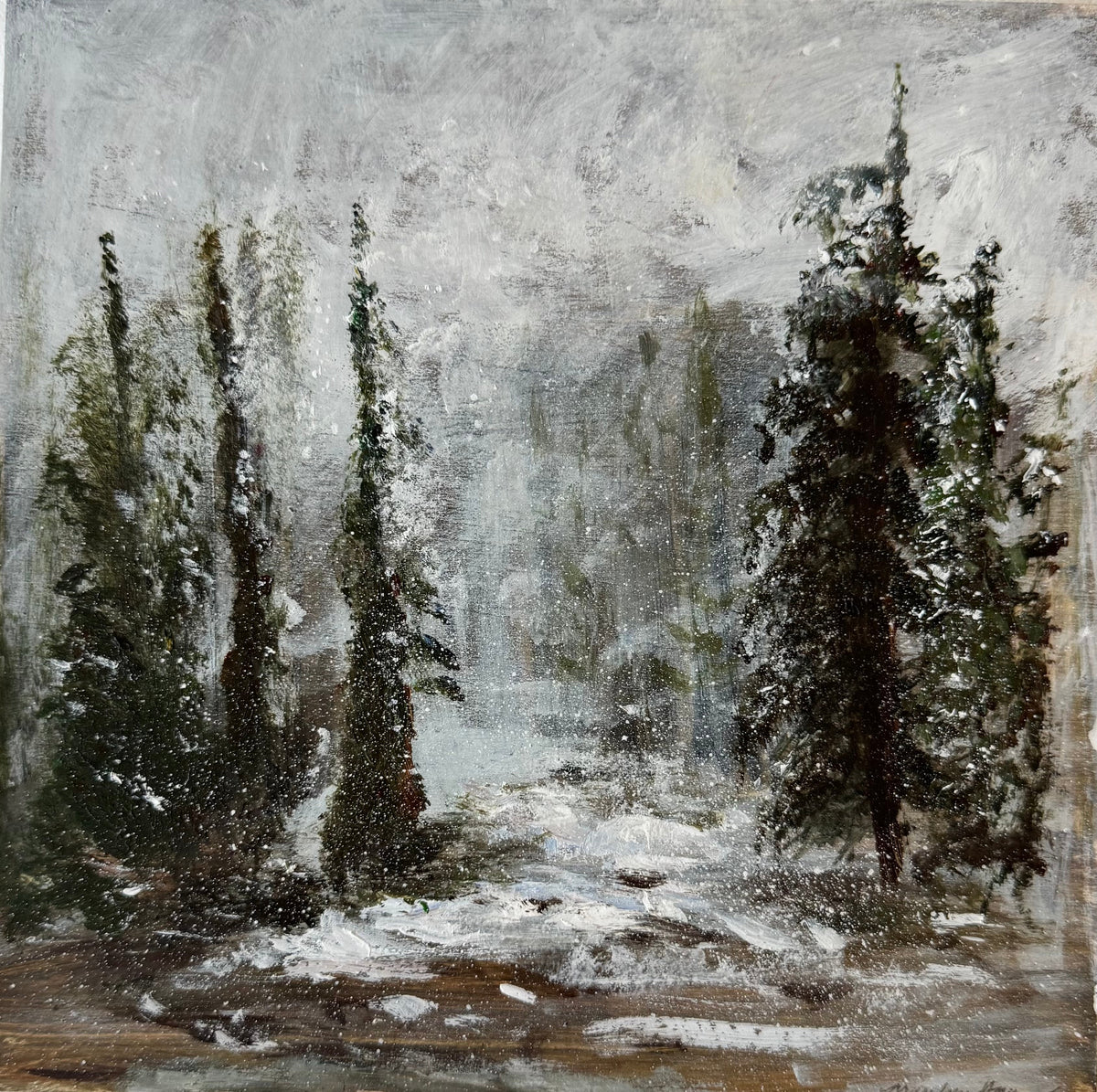 A square canvas painting of a snowy forest scene with tall dark evergreen trees, mounted on a textured off-white wall.